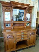 Satinwood dresser with central cupboards and recess below flanked by two Cupboards in the Art Deco