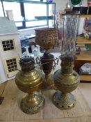 An ornate lamp and two oil lamps