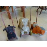 Three plush bodied push along dogs all on metal frames