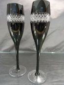 Pair of Champagne flutes by John Rocha for Waterford Crystal. Black Glass with a band of Diamond