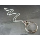 Silver magnifying glass with frog on chain