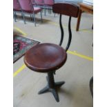 Singer Sewing machinist stool with cast iron base and marked 'Singer' to each foot.