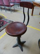 Singer Sewing machinist stool with cast iron base and marked 'Singer' to each foot.