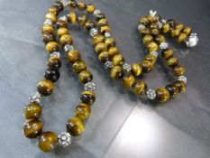 Recently re-strung Tigers eye bead and flower spacer necklace approx 26" long with ball strong