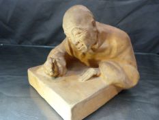 Gaston Hauchecorne (1880-1945) - Terracotta figure of an oriental man leaning over table looking