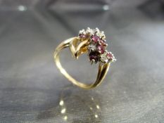 A 14ct yellow gold ring set with a cluster of rubies and diamonds