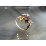 A 14ct yellow gold ring set with a cluster of rubies and diamonds