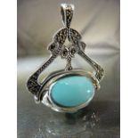 Silver revolving fob in the style of a swivel seat set with semi precious stones to include: -