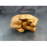 Carved Netsuke of a stylized dog