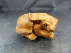 Carved Netsuke of a stylized dog