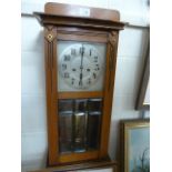 Antique mahogany wall clock Some damage. With bevelled glass door. Key and Pendulum in office