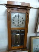 Antique mahogany wall clock Some damage. With bevelled glass door. Key and Pendulum in office