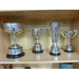 Four trophy cups on stands. All silverplate with inscriptions.