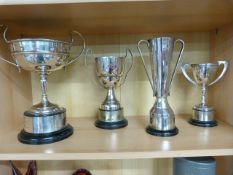 Four trophy cups on stands. All silverplate with inscriptions.