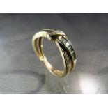 Modern cross over style 9ct gold ring with emeralds and diamonds