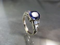 18ct white gold ring set with a pale ceylon Sapphire oval in shape and with stepped baguette