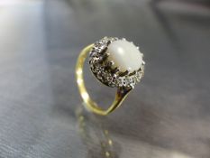 White Opal and Diamond ring. 18ct ring with large central Opal surrounded by set diamonds