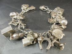 Silver Charm Bracelet with large quantity of various charms - 26 in total approx. Approx weight -