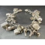 Silver Charm Bracelet with large quantity of various charms - 26 in total approx. Approx weight -