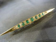 Diamond & Emerald Victorian Bar brooch consisting of seven graduated Emeralds set with eighteen
