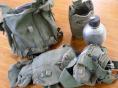 Green military kit bag with contents