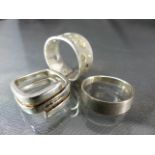 Three silver rings including one by Fossil set with five small square CZ stones