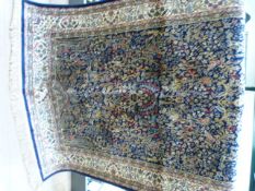 Blue ground carpet with all over floral detailing on a cream border