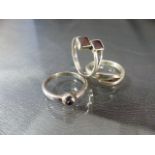 Three silver rings including one Amethyst set and one garnet set ring. Approx weight - 7.7g