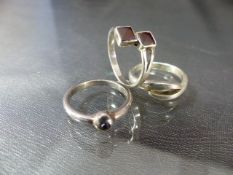 Three silver rings including one Amethyst set and one garnet set ring. Approx weight - 7.7g