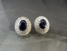 Pair of silver CZ and large sapphire earrings