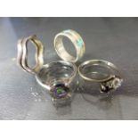 Four silver rings including an 8.1mm diameter mystic topaz stone