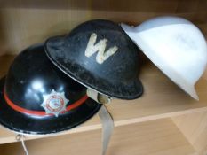Devon County Fire and Rescue Service metal helmet and two other warden helmets - 2 shelves