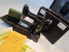 A vintage Singer portable electric sewing machine. No 222k in carry case with accessories, lead