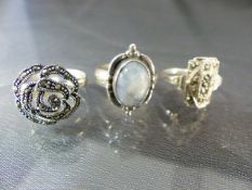 Three silver rings including 2 marcasite rings and 1 moonstone set ring. Total approx weight - 12.