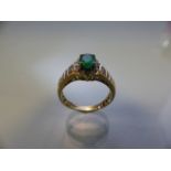 14CT yellow gold emerald and diamond ring, the large central stone surrounded by diamonds