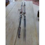 Pair of African spears, leather bound with tribal decoration, one spearhead is covered with a
