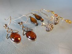 Bag of earrings to include Amber set celtic drops, silver Marcasite flowers and others