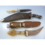 Four hand held knives - to include two Kuhkri type knives, one other with unusual handle of orange