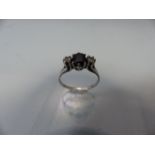 White Gold ladies dress ring with central sapphire and diamonds to shoulders (hallmarks rubbed)