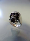 Silver skull ring with ruby eyes