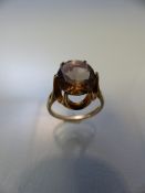 9ct Gold ring with high setting supporting a large Citrine