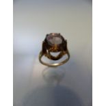 9ct Gold ring with high setting supporting a large Citrine