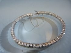 18ct white gold, Diamond set line bracelet. 18ct white gold, trap set mount with box snap clasp, a