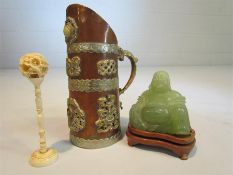 Oriental banded copper and brass water jug with lion handle and motifs along with a jade-style