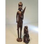 Two African statues carved in ebony coloured hardwood - one tribal warrior with spear. The other a