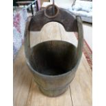 An antique well bucket with cast metal fittings