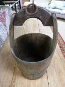 An antique well bucket with cast metal fittings