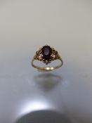 9ct gold ladies dress ring with Ruby coloured stone in decorative mount