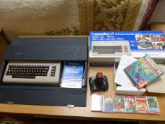 Commodore 64 Microcomputer and games with joystick. Comes with original box and carry case for the