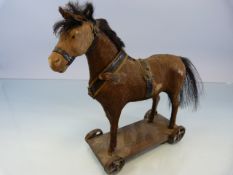 German Pull-Along Toy horse with real horse hair. Metal cast wheels c.1890.